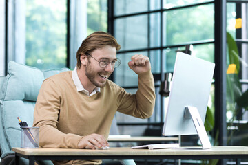 A successful young entrepreneur, a business owner, works in a modern office computer, a businessman...