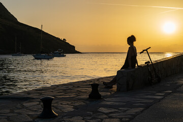 silhouette of a person on the pier at sunset