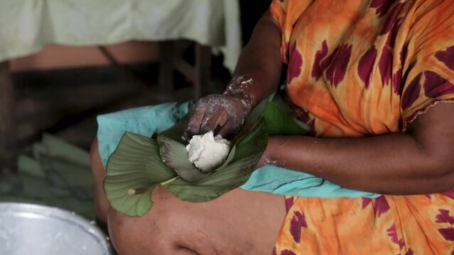 An African woman prepares a dish according to a traditional African recipe.  Africa. Equatorial Guinea. Inside an African house.