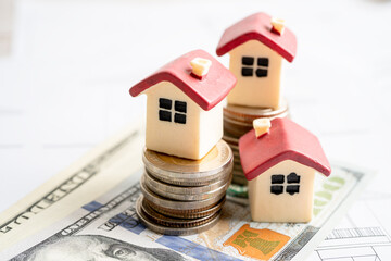 House with stack coins and uS dollar money on plan house, mortgage home loan finance concept.