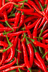 macro red chili background,Red hot chili peppers pattern Chili texture background. Close up landscape background of hot chili peppers. Roadside vegetable market. Red chili gro