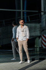Brutal bearded man hipster in fashionable summer white clothes in sunglasses in stylish white...