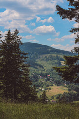 view of landscape with mountains and trees and blue sky in summer, czech nature, czech mountains