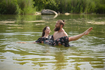 caucasian couple in love having a bath in a lake