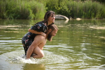 caucasian couple in love having a bath in a lake