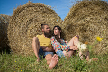 Naklejka na ściany i meble lovely caucasian couple in love in front of straw bales