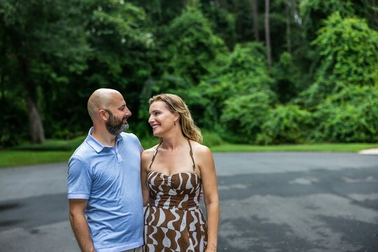 A Caucasian Couple In Their Forties Outside Looking At One Another With Copy Space