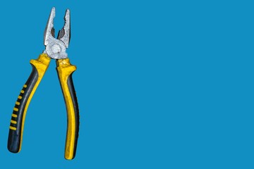 Modern and beautiful pliers on a blue background