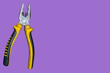 Modern and beautiful pliers on a purple background