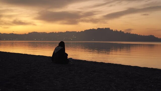 Girl on the shore looking at the lake in puerto varas chile