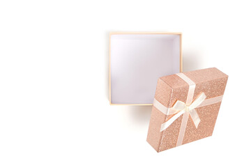 Open gift box with beige ribbon and bow white background.