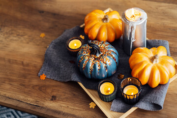 Autumn, fall cozy mood composition for hygge home decor. Decorative orange and gray pumpkins and...