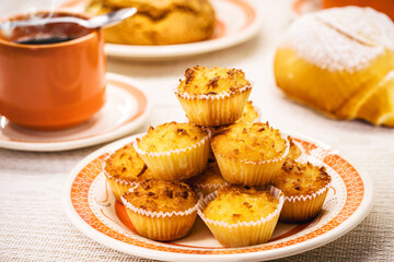 Queijadinha or queijada, sweet baked dessert from a traditional bakery and pastry shop from Brazil and Portugal, made with eggs, cheese or coconut, and lots of sugar.