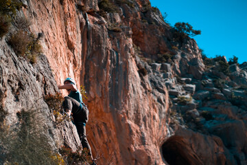 Man is climbing, hiking in the mountains.