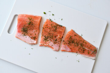 Pieces of raw trout sprinkled with spices