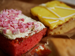 Decorated homemade cake with icing and pink sprinkles close up