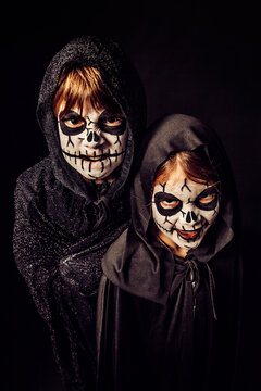 Two kids with scary face paint at Halloween