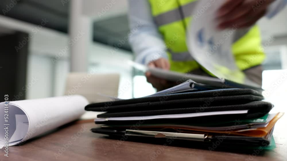 Poster Work, files and documents of building or architectural plans on an office table with contractor. Architect, building planner or construction worker reading an engineering document to analyze plans