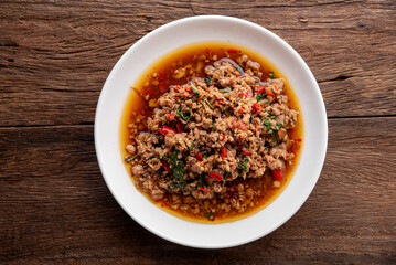 Rice topped with stir-fried pork and basil. Stir fried basil. on wooden table background. top ten thaifood menu