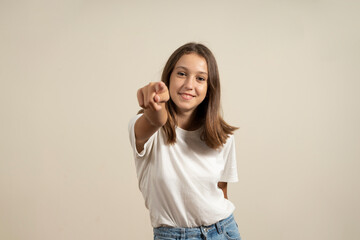 I choose you and command you. The smiling teenage girl pointing at camera, half-length close-up...