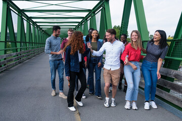 Obraz premium Group of young people from different cultures having a fun time outdoors