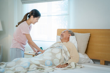 Obraz premium Asia daughter help and take care of senior father in bedroom in house.