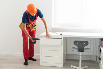 repairman installs furniture in the children's room.