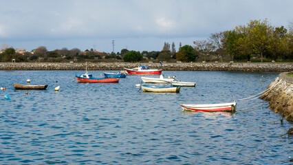 Fototapeta na wymiar Fishing boats anchored in a bay doing fishing work