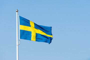 swedish flag on blue sky - obrazy, fototapety, plakaty