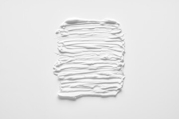 White smear of cosmetic cream or acrylic paint isolated on white background.