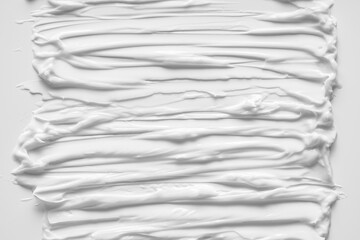 Obraz premium White smear of cosmetic cream or acrylic paint isolated on white background.