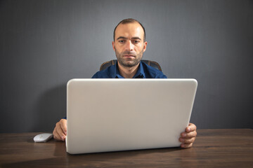 Caucasian man working with laptop computer.