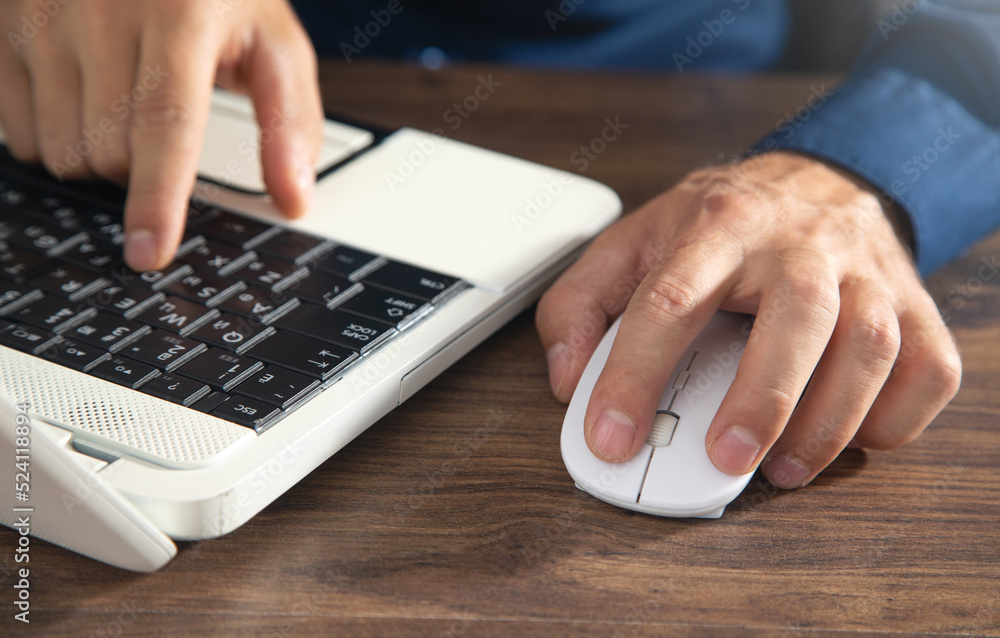 Poster male hand clicking computer mouse and typing in computer keyboard. internet. business. technology