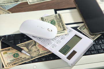 Computer mouse and money on computer keyboard.