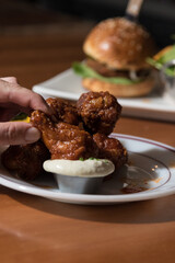 hand holding a fried chicken wings 