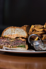 Section of beef burger with fries
