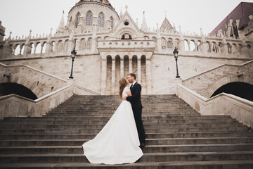 Gorgeous happy couple standing close to each other and looking in eyes