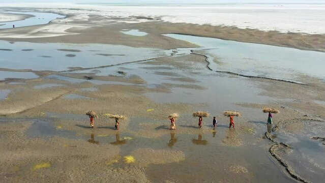People crossing desert like huge sandbars in Bangladesh.