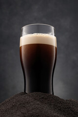 Dark stout pours into a beer glass. Selective focus