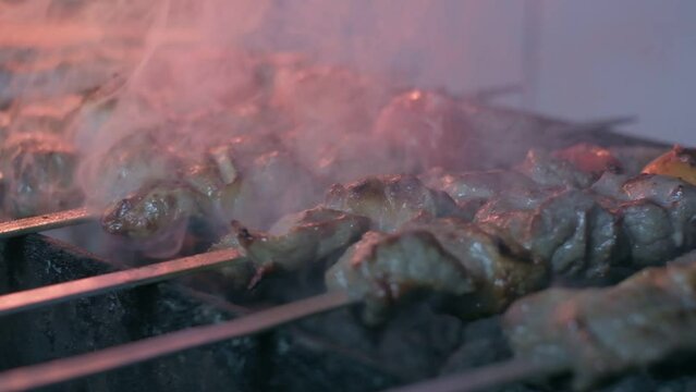Close-up of lumpy kebab with tomato and ground kebab is grilled on the grill