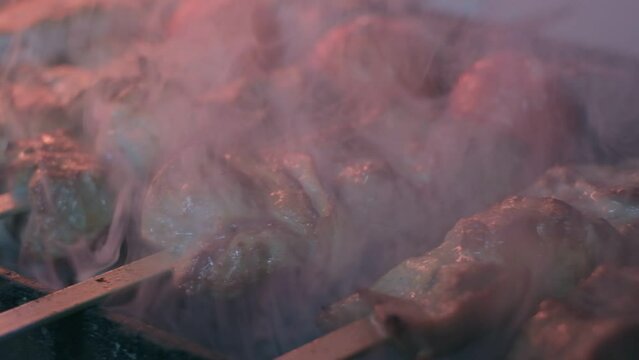 Close-up of lumpy kebab with tomato and ground kebab is grilled on the grill