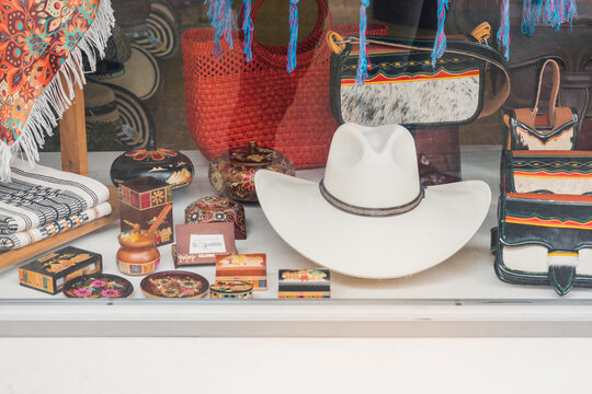 aguade&ntilde;o hat together with carriels and handicrafts exhibited in a showcase of a handicraft store in Pereira-Colombia. typical costume of the paisa region of Colombia.