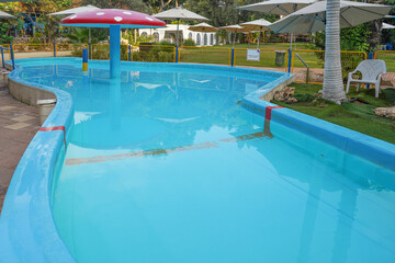 Empty childrens pool. Childrens swimming pool with sunny reflections