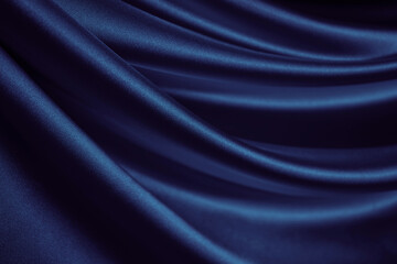 Black blue silk satin. Dark elegant background with space for design. Soft folds. Wavy. Shiny...