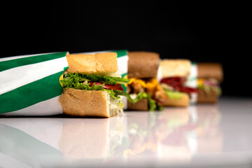 sandwiches in a package are on the table on a black background