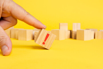 wooden block in exclamation mark on yellow background