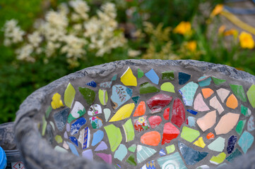 Homemade mosaic flower pot with porcelain pieces. Recycling, broken tableware, ceramics, crafts, mosaics.