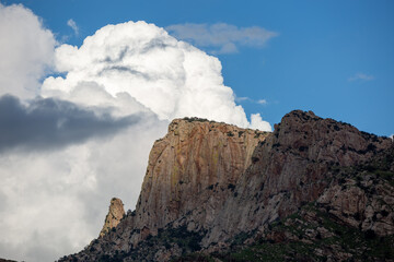 Push Ridge along the western edge of the Catalina Mountains in the Coronado National Forest north of Tucson. Monsoon storm clouds build behind a towering wall of rock. Pima County, Arizona, USA.