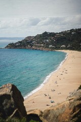 Vertical shot of people relaxing on Bolonia beach in Tarifa, Spain