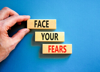 Face your fears and support symbol. Concept words Face your fears on wooden blocks. Businessman...